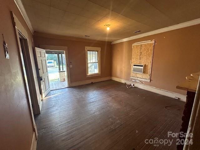 interior space with heating unit, dark hardwood / wood-style flooring, and ornamental molding