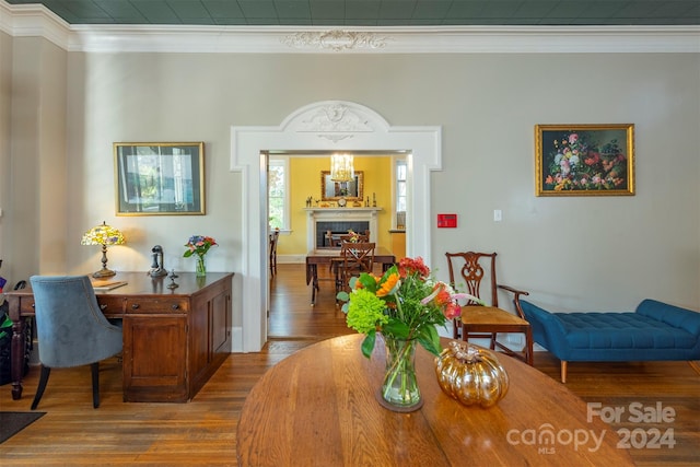 dining area with ornamental molding and hardwood / wood-style flooring