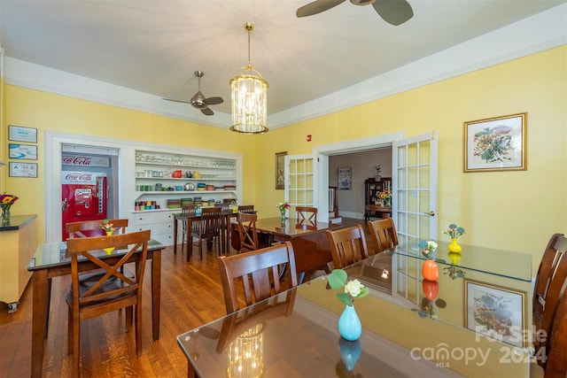 dining area with hardwood / wood-style floors, ceiling fan, and crown molding