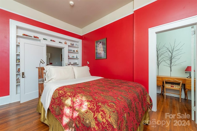 bedroom with dark hardwood / wood-style floors