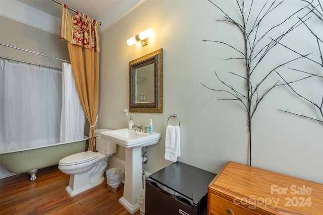 full bathroom featuring shower / bath combination with curtain, hardwood / wood-style flooring, toilet, and sink