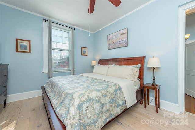 bedroom featuring light hardwood / wood-style floors, ceiling fan, and ornamental molding