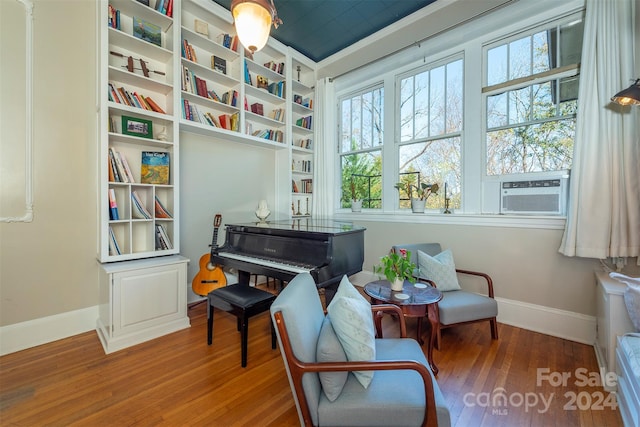 sitting room featuring cooling unit and hardwood / wood-style flooring