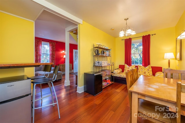 dining area featuring hardwood / wood-style floors and a chandelier