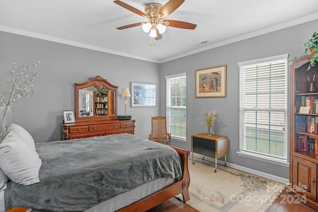 bedroom featuring wood-type flooring, ceiling fan, and crown molding