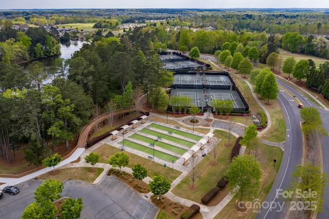 drone / aerial view featuring a water view and a view of trees