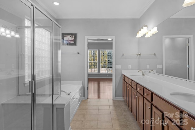 bathroom featuring tile patterned flooring, crown molding, and a sink