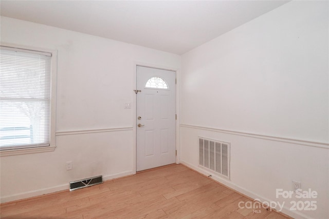 entryway with a healthy amount of sunlight and light hardwood / wood-style floors