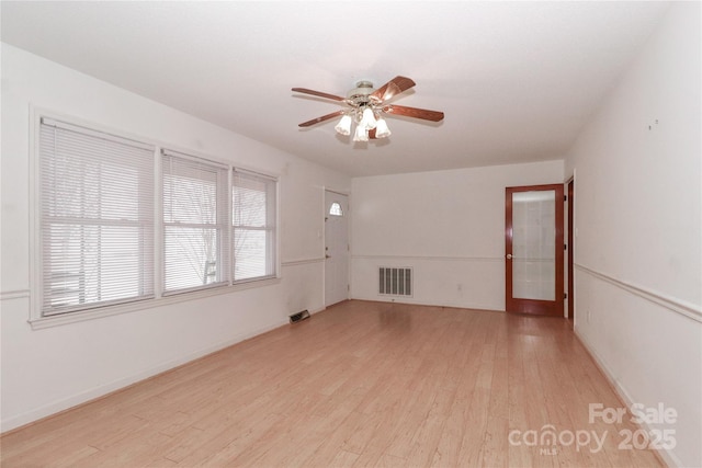 empty room featuring ceiling fan and light hardwood / wood-style flooring