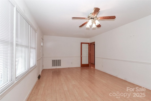 unfurnished room with ceiling fan and light wood-type flooring