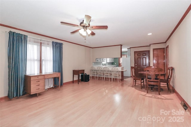 interior space with ceiling fan, crown molding, and light hardwood / wood-style floors