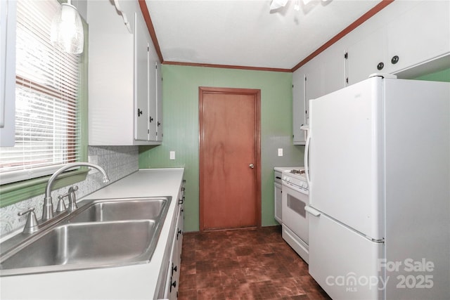 kitchen featuring white appliances, white cabinetry, sink, backsplash, and crown molding