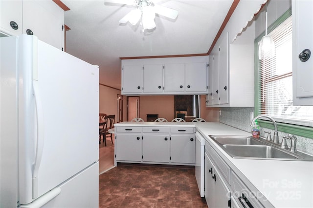 kitchen with a healthy amount of sunlight, sink, white appliances, and white cabinetry