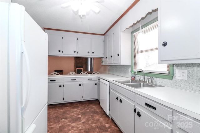 kitchen with white appliances, white cabinets, sink, ceiling fan, and crown molding