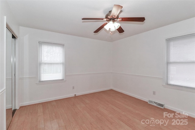 spare room with ceiling fan and light hardwood / wood-style floors