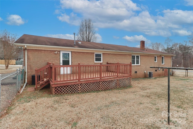 back of property featuring a deck, cooling unit, and a yard