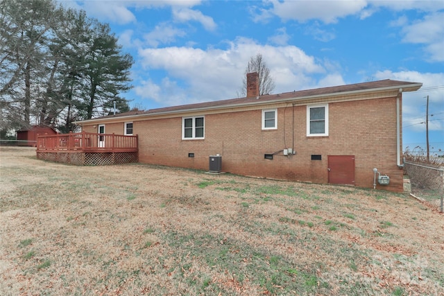 rear view of house featuring a deck, central AC, and a yard