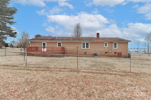 rear view of house with a wooden deck and a yard