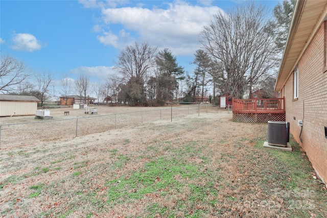 view of yard with a deck and central AC