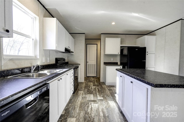 kitchen featuring sink, dark wood-type flooring, a kitchen island, white cabinets, and black appliances