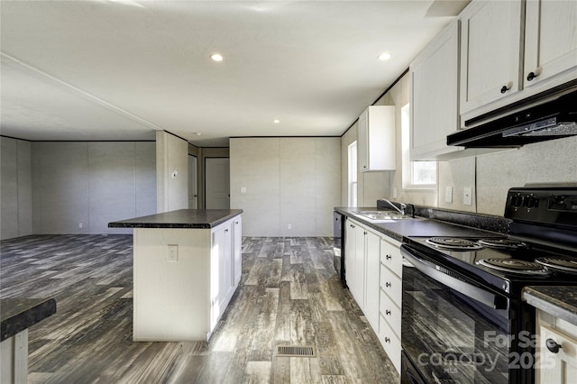 kitchen with black appliances, a center island, and white cabinets