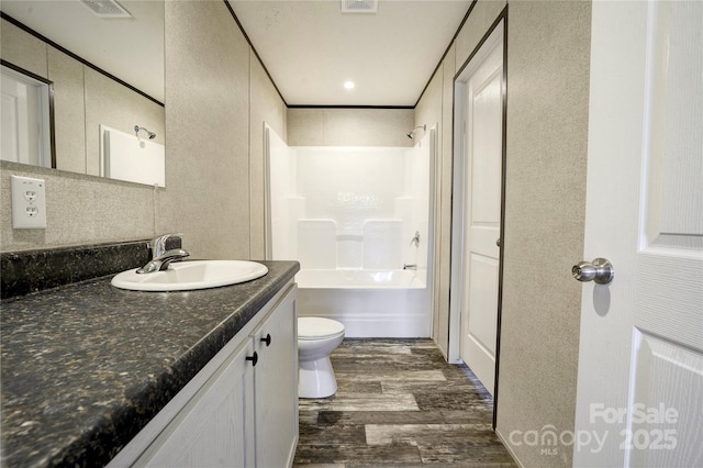 full bathroom featuring vanity, toilet, shower / bathing tub combination, and hardwood / wood-style flooring