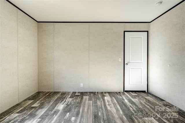 unfurnished room featuring dark hardwood / wood-style flooring and ornamental molding