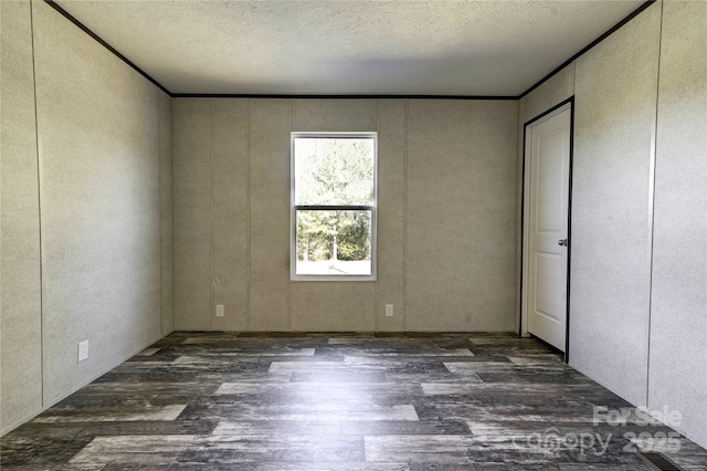 unfurnished bedroom with dark hardwood / wood-style flooring and a textured ceiling