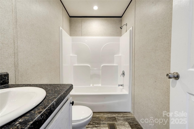 full bathroom with wood-type flooring, vanity, toilet, and shower / bathtub combination