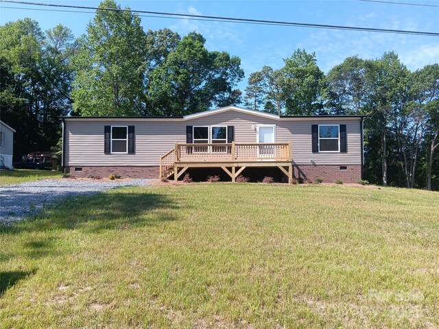 1245 Cleveland Ave, Grover, NC 28073 - manufactured / mobile home with crawl space, a deck, and a front lawn