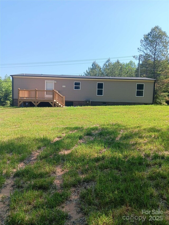 1245 Cleveland Ave, Grover, NC 28073 - rear view of property with a deck, a lawn, and central air condition unit