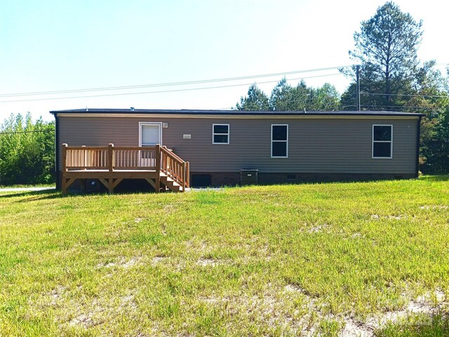 1245 Cleveland Ave, Grover, NC 28073 - rear view of property featuring crawl space, a wooden deck, a lawn, and central AC