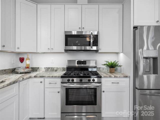 kitchen featuring white cabinetry and appliances with stainless steel finishes