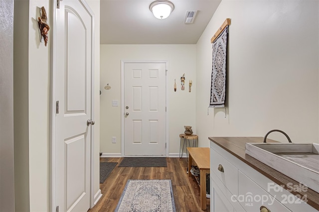 doorway with dark wood-type flooring