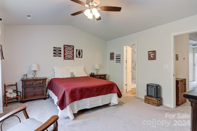 bedroom featuring ensuite bath, light carpet, ceiling fan, and vaulted ceiling