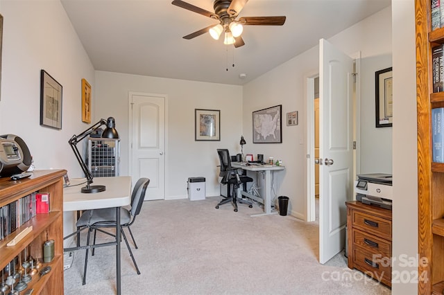 office space with ceiling fan and light carpet