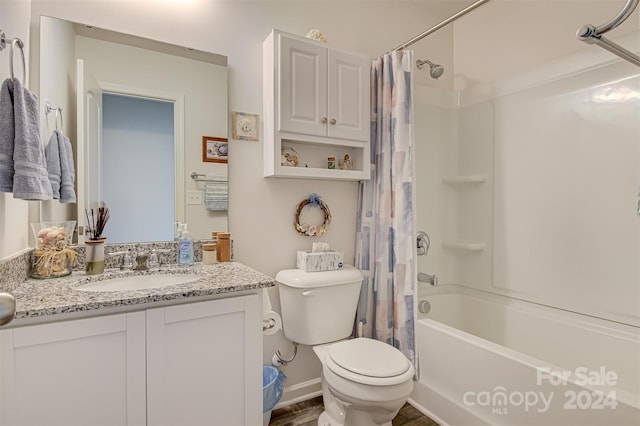 full bathroom featuring shower / tub combo with curtain, vanity, and toilet