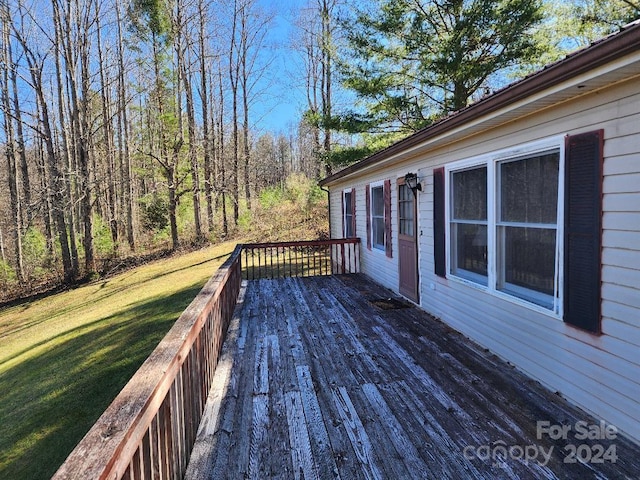 wooden deck with a lawn