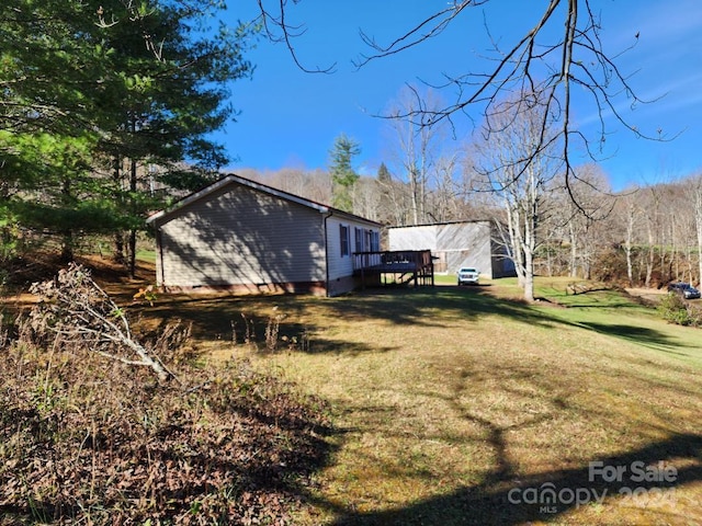 exterior space featuring a lawn and a wooden deck