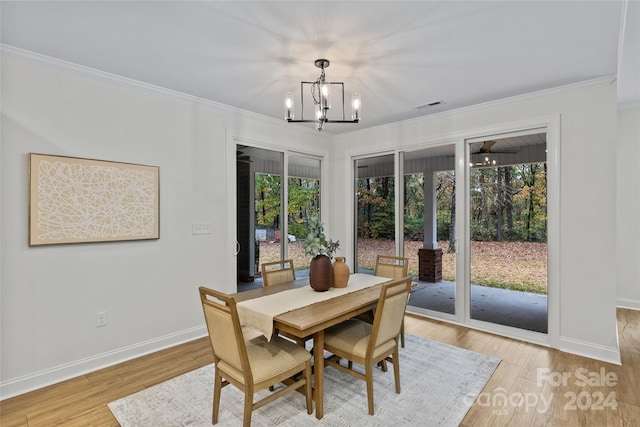 dining area featuring ornamental molding, ceiling fan with notable chandelier, a healthy amount of sunlight, and light hardwood / wood-style flooring