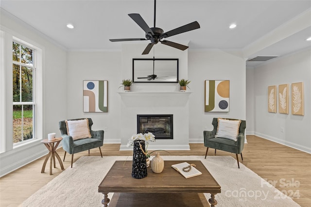 living room featuring ceiling fan, hardwood / wood-style flooring, and ornamental molding