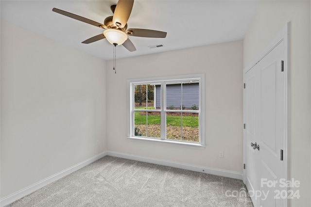 unfurnished room with ceiling fan and light colored carpet