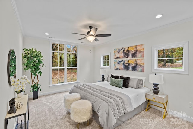 carpeted bedroom with ceiling fan and ornamental molding