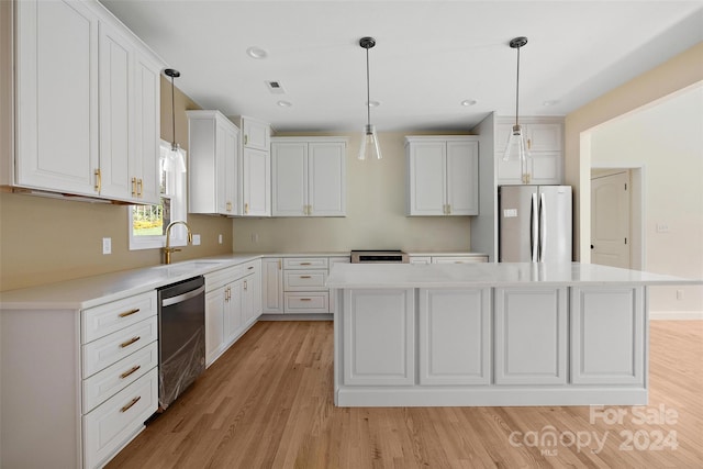 kitchen with light wood-type flooring, white cabinetry, a center island, and stainless steel appliances