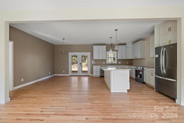 kitchen with stainless steel appliances, light hardwood / wood-style floors, a kitchen island, white cabinets, and pendant lighting