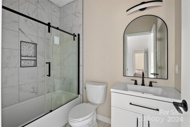 full bathroom with bath / shower combo with glass door, vanity, and toilet