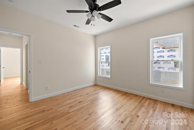 empty room with light hardwood / wood-style floors and ceiling fan