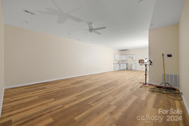 unfurnished living room with light wood-type flooring and ceiling fan