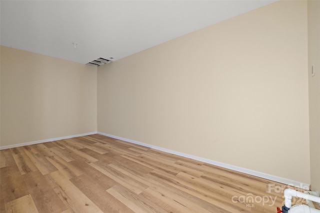 spare room featuring light hardwood / wood-style flooring