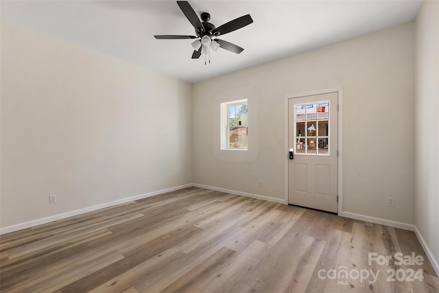 empty room with light wood-type flooring and ceiling fan